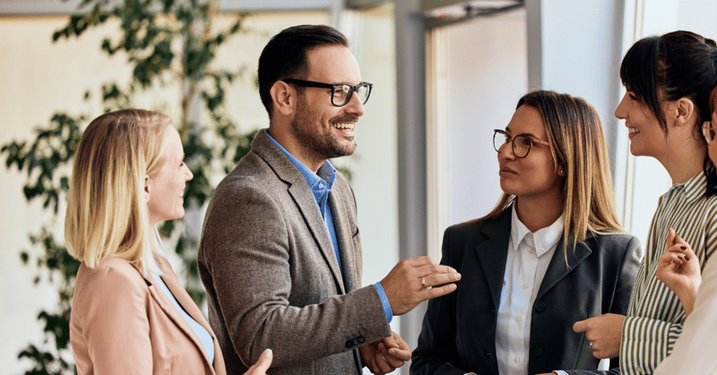 Group of professionals exchanging ideas in a collaborative office environment.